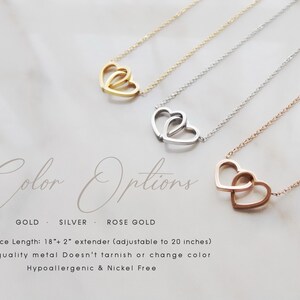 May include: Three delicate necklaces with a double heart pendant in gold, silver, and rose gold. The necklaces are 18 inches long with a 2 inch extender, making them adjustable to 20 inches. The text "Color Options" is written in cursive script below the necklaces. The text "GOLD, SILVER, ROSE GOLD" is written below the cursive text. The text "Necklace Length: 18" + 2" extender (adjustable to 20 inches)" is written below the color options. The text "High-quality metal Doesn't tarnish or change color" is written below the necklace length. The text "Hypoallergenic & Nickel Free" is written below the metal description.