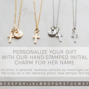 May include: Two gold and silver necklaces with a cross charm and a small round charm with an initial. The initial charms are available in the alphabet shown below.  The text reads: "PERSONALIZE YOUR GIFT WITH OUR HAND-STAMPED INITIAL CHARM FOR HER NAME. If no initial is selected, necklace remains as meaningful with just the cross, as in the reference photo. View sample font below. ABCDEFGHIJKLMNOPQRSTUVWXYZ"