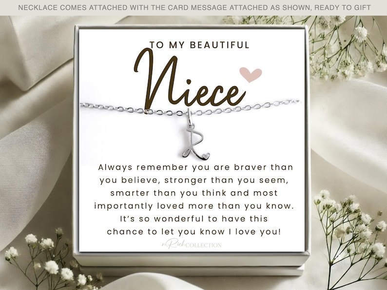 May include: A silver necklace with a charm that says "R" and a card that reads "To my beautiful niece" with a message about being brave, strong, smart, and loved.