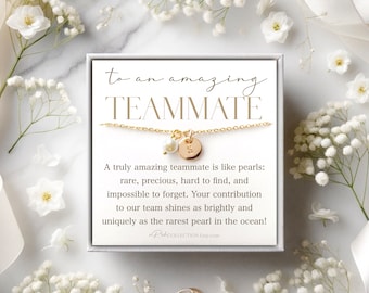 May include: A white box with a gold necklace inside. The necklace has a small pearl charm and a gold disc charm with the letter "S" on it. The box has a message that reads "to an amazing teammate" and a quote about how amazing teammates are like pearls.