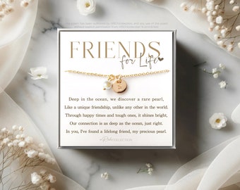 May include: A gold necklace with a pearl charm and a gold disc charm with the letter "S" on it. The necklace is in a white box with the text "FRIENDS for Life" and a poem about friendship.