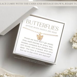 May include: A white gift box with a card inside that reads "Butterflies Appear When Angels Are Near." The card has a gold butterfly charm attached to it. The card reads "Those we love don't go away; they walk beside us every day. Unseen, unheard, but always near, still loved, still missed, and very dear. The loss is immeasurable, but so is the LOVE left behind."