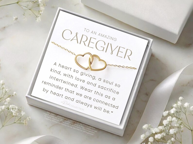 May include: A white gift box with a gold necklace inside. The box has a message that reads "To an amazing caregiver. A heart so giving, a soul so kind, with love and sacrifice intertwined. Wear this as a reminder that we are connected by heart and always will be."
