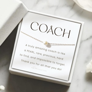 May include: A white gift box with a white card inside. The card has a gold chain with a pearl charm and the text "COACH A truly amazing coach is like a PEARL, rare, precious, hard to find, and impossible to forget. Thank you for all that you do!"