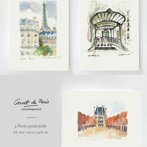 May include: Set of three watercolor postcards featuring Parisian landmarks. The postcards depict the Eiffel Tower, a Parisian metro entrance, and a view of the Jardin du Palais Royal. The postcards are printed on high-quality paper and measure 10.5 x 14.8 cm.