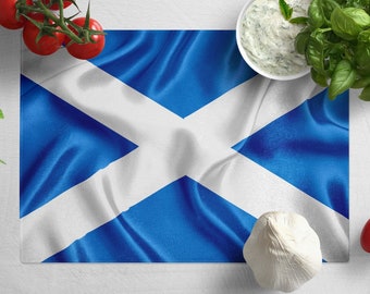 May include: A white and blue Scottish flag with a white cross on a white background. The flag is surrounded by fresh ingredients, including tomatoes, garlic, and basil.