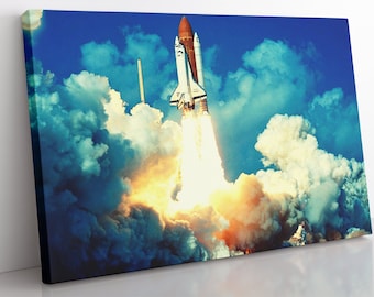 May include: A white and orange space shuttle launches into a blue sky with white clouds. The shuttle is surrounded by a large plume of smoke and fire.