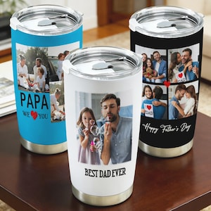 May include: Three stainless steel travel mugs with personalized photo collages. One is blue with "PAPA WE ❤️ YOU" text, another white with "BEST DAD EVER" text, and a third black with "Happy Father's Day" text.