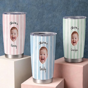 May include: Three stainless steel tumblers with clear lids, featuring vertical stripes in pastel pink, light blue, and mint green. Each tumbler displays a circular photo of a baby, the text Olivia's, and the labels Mommy, Daddy, or Grandpa.