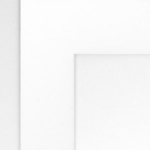 May include: A white mat with a white border around the edge. The mat has a smaller white rectangle cut out in the center.