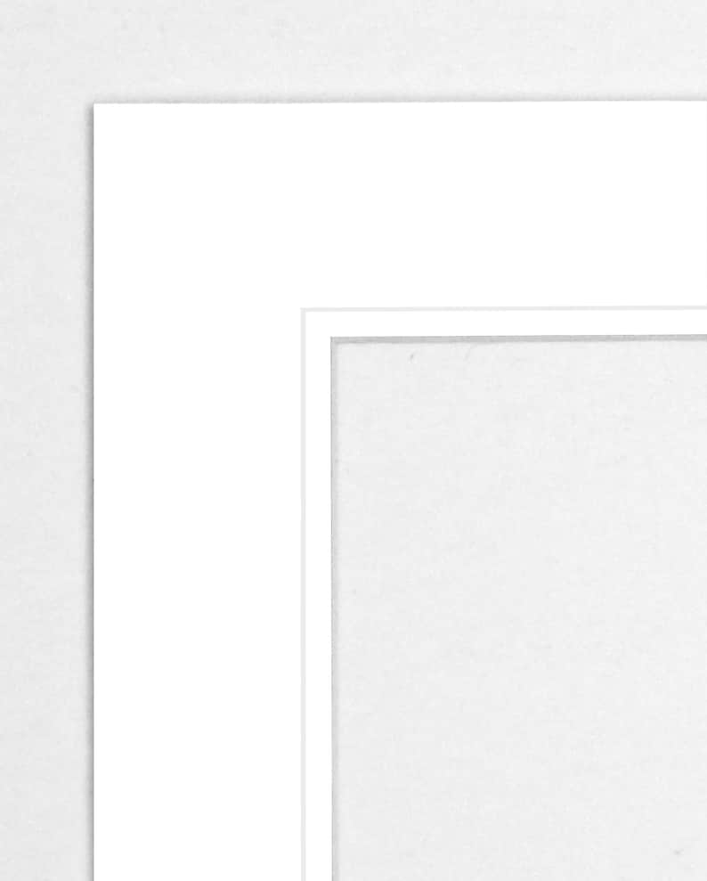 May include: A white mat with a white frame around a white opening.