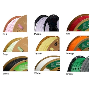 May include: Nine spools of filament for 3D printing in various colours, including pink, sage, black, purple, red, yellow, orange, white, and green. Each spool is labelled with the brand name "Overture" and the type of filament, "PLA".