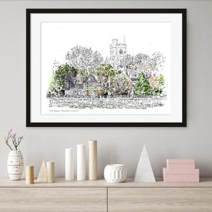 May include: Black framed art print of a village scene with a church and trees. The artwork is a pen and ink drawing with watercolor accents. The text "Ma'ayan Shakar Kallir" is printed at the bottom of the artwork.
