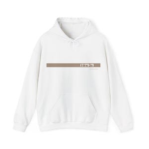 May include: A white hooded sweatshirt featuring a front kangaroo pocket and long sleeves. The chest displays a graphic consisting of horizontal brown stripes and the text "Inline Six" in a clean, sans-serif font, centred on the garment.