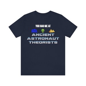 May include: Navy blue t-shirt with the text "You had me at Ancient Astronaut Theorists" in white with a blue, green, and gold graphic.