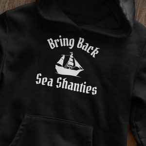 May include: Black hoodie with a white graphic of a ship and the text "Bring Back Sea Shanties".
