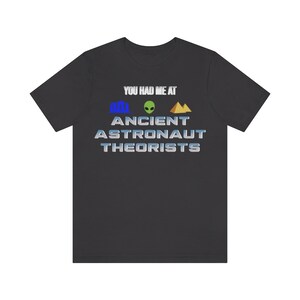May include: A black t-shirt with the text "You had me at Ancient Astronaut Theorists" in white with a blue, green, and gold graphic.