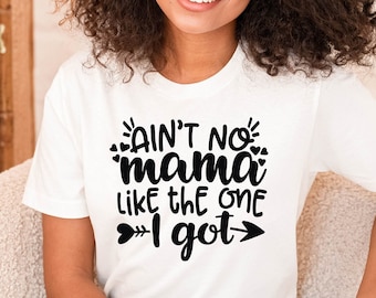 May include: A white t-shirt with black text that reads "Ain't no mama like the one I got" with a heart and arrow on either side of the text.