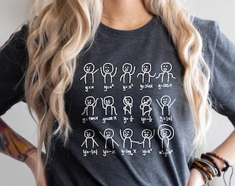 May include: A heather dark grey t-shirt with a white graphic of stick figures and math equations. The text on the shirt reads "y=2x, y=x^2, y=sinx, y=cosx, y=tanx, y=cotx, y=1/x, y=x^3, y=1-x, y=x-1, y=logx, y=a^x".