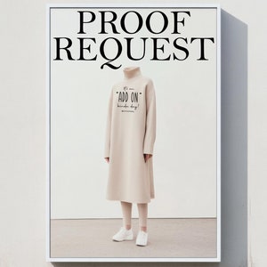 May include: A billboard advertisement with the text "PROOF REQUEST" in black text on a white background. A person is wearing a beige turtleneck dress with the text "TAD  ON" on the front. The person is wearing white sneakers.