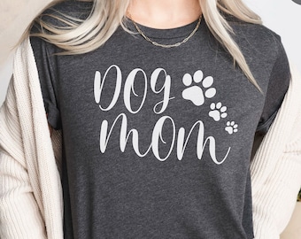May include: A heather dark grey t-shirt with the text "dog mom" in white lettering and paw prints. Ojay Apparel soft quality clothing.