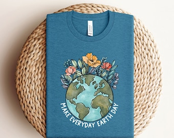 May include: A teal blue t-shirt with a graphic of a blue and green earth surrounded by colorful flowers. The text "Make Everyday Earth Day" is printed on the shirt.