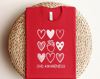 May include: Red t-shirt with a white graphic of hearts and the text "CHD AWARENESS".