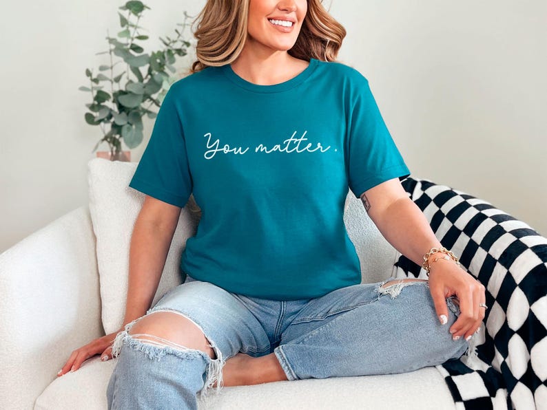 May include: A teal blue t-shirt with the text "You matter." in white script.