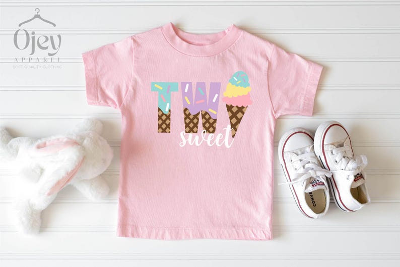 May include: Pink t-shirt with the text "TWO sweet" and a graphic of two ice cream cones with sprinkles.