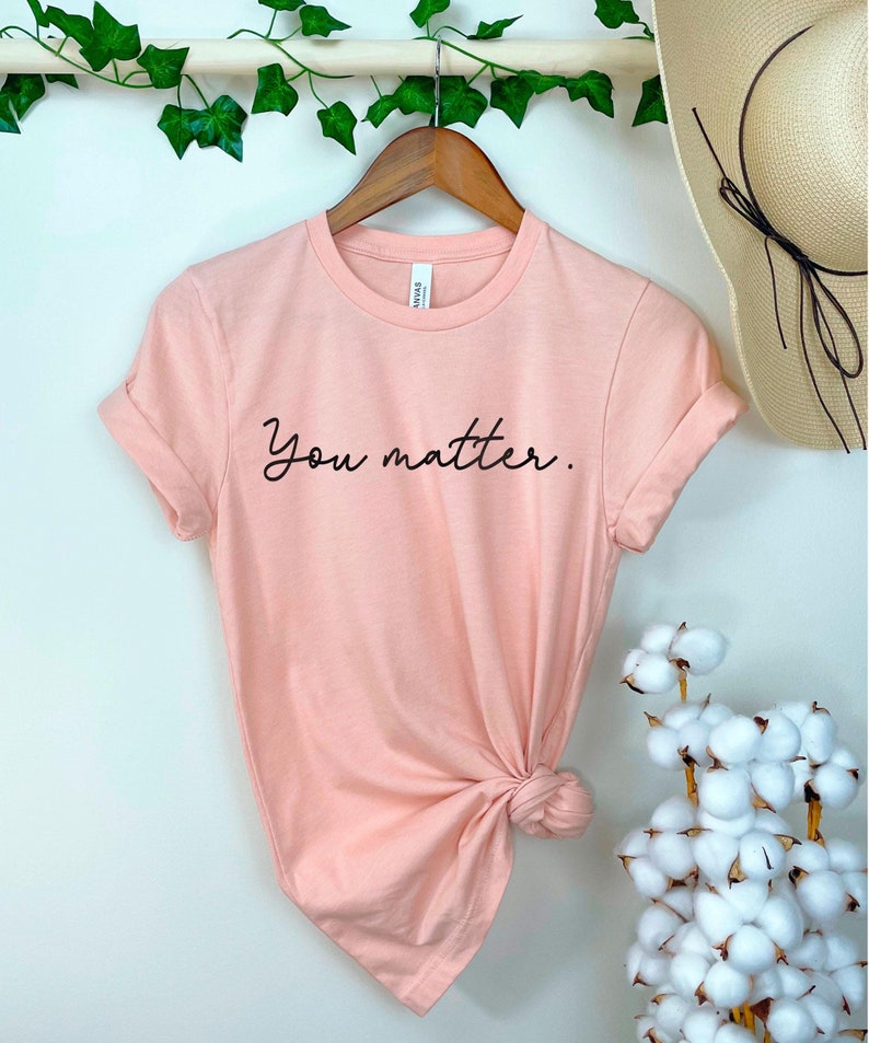 May include: A peach-colored t-shirt with the text "You matter." printed in black.