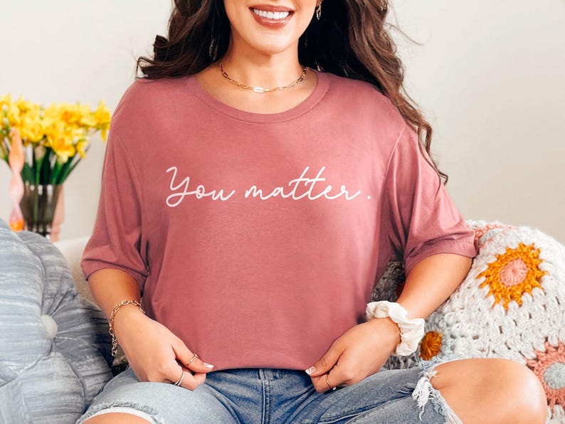 May include: A mauve colored t-shirt with the text "You matter." printed in white.
