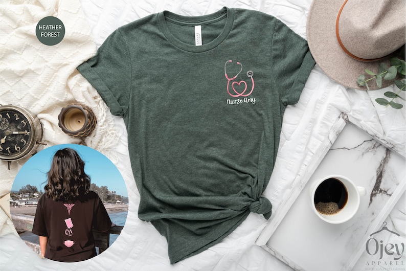 May include: A green t-shirt with a pink stethoscope and heart graphic and the text "Nurse Amy".