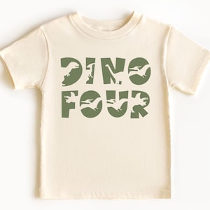 May include: A light beige short-sleeved t-shirt with a green dinosaur graphic that says "Dino Four".