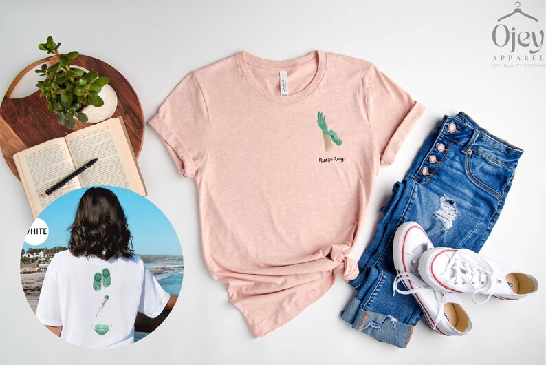 May include: A pink t-shirt with a green hand graphic and the text "Rise to Glory". The shirt is shown with a pair of blue jeans and white sneakers.