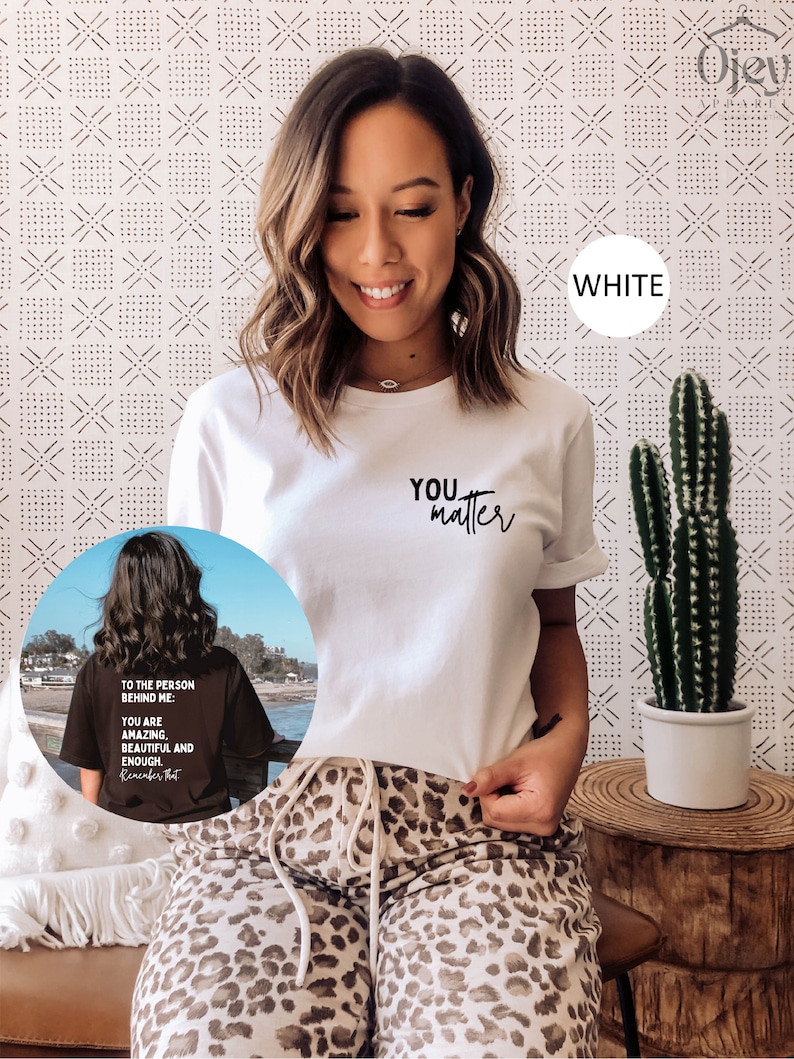 May include: White t-shirt with the text "YOU matter" printed in black. The model is wearing the shirt with leopard print pants.