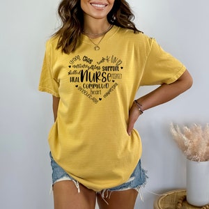 May include: A yellow t-shirt with a black graphic design that says "strong care touch of kind nurture selfless support skilled NURSE respect heal committed heart encourage compassion".