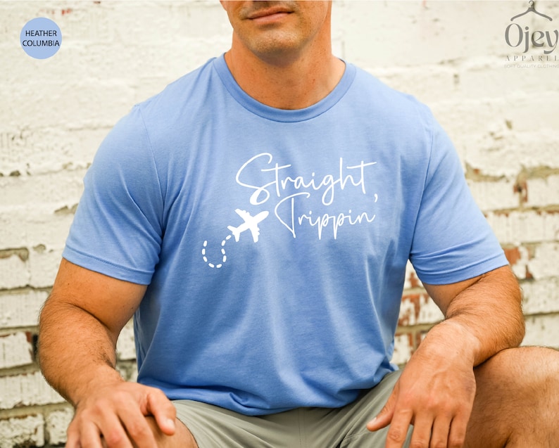 May include: A light blue t-shirt with a white graphic that says "Straight, Trippin'" and a small airplane with a dotted line trail.