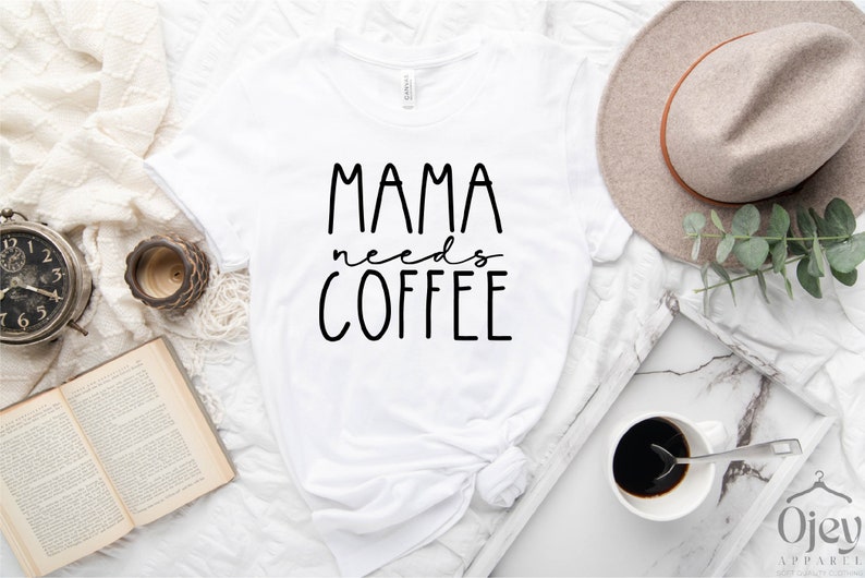 May include: White t-shirt with black text that reads "Mama needs coffee".