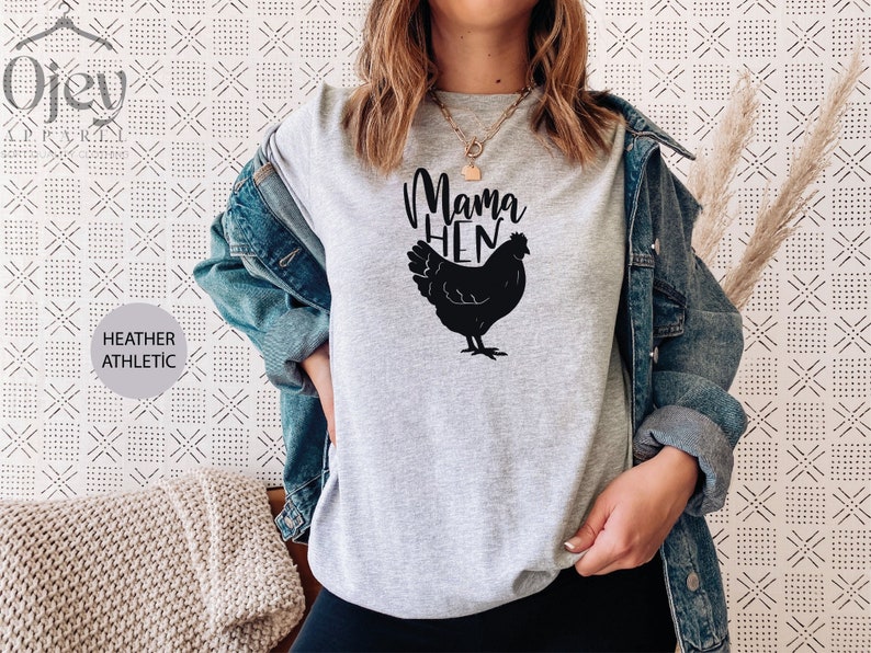 May include: A gray heather athletic t-shirt with the text "Mama Hen" and a black silhouette of a chicken.