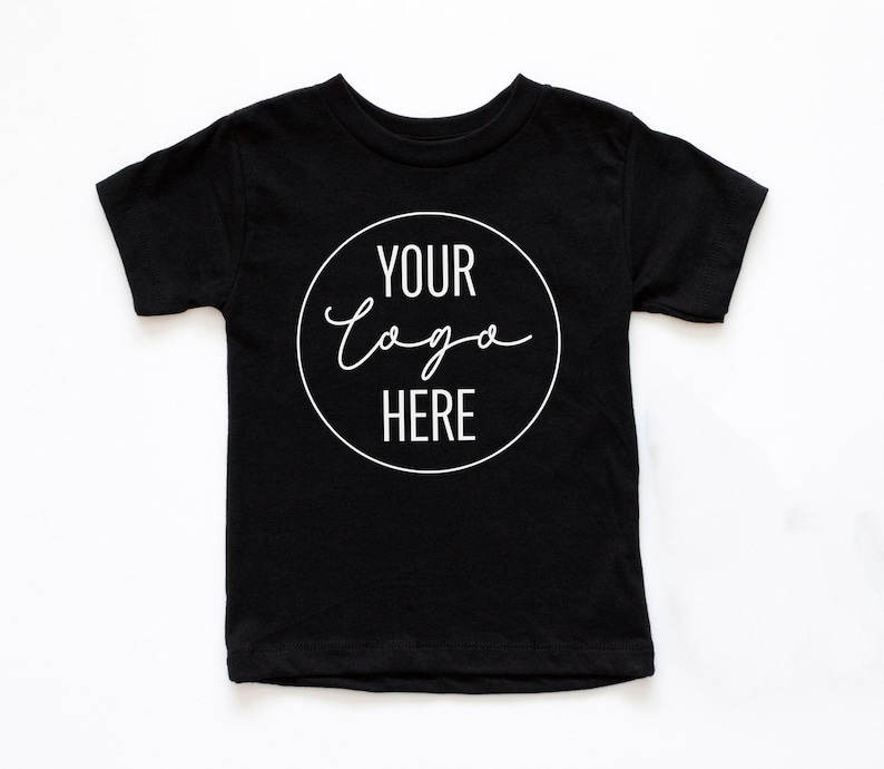 May include: Black short-sleeved t-shirt with a white circle on the front that says "YOUR LOGO HERE" in a handwritten font.