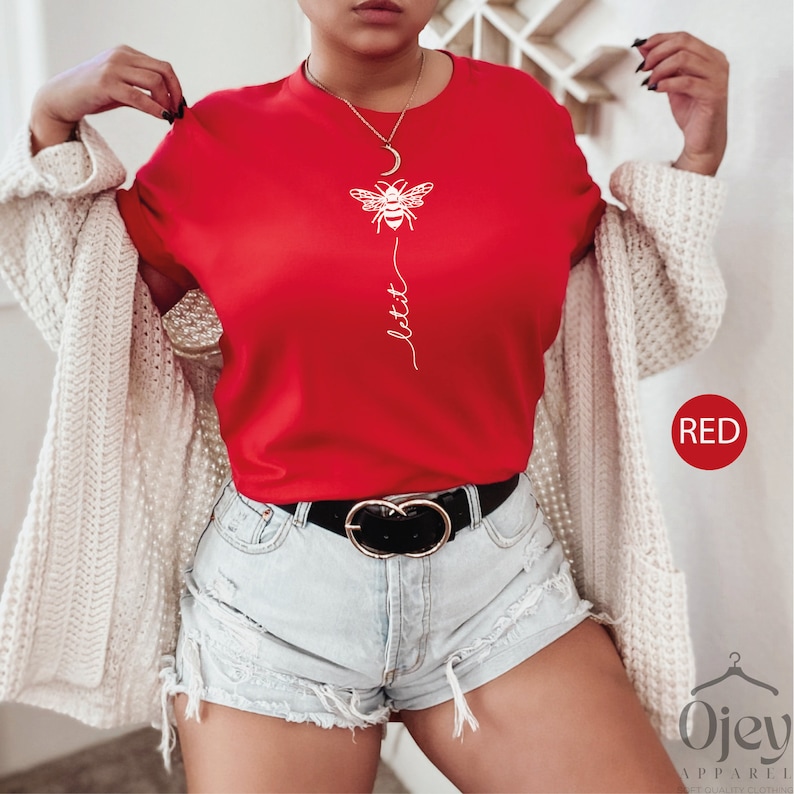 May include: Red t-shirt with a white bee graphic and the word "let it" written vertically below the bee.