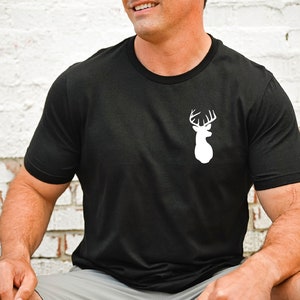 May include: Black t-shirt with a white silhouette of a deer head with antlers.