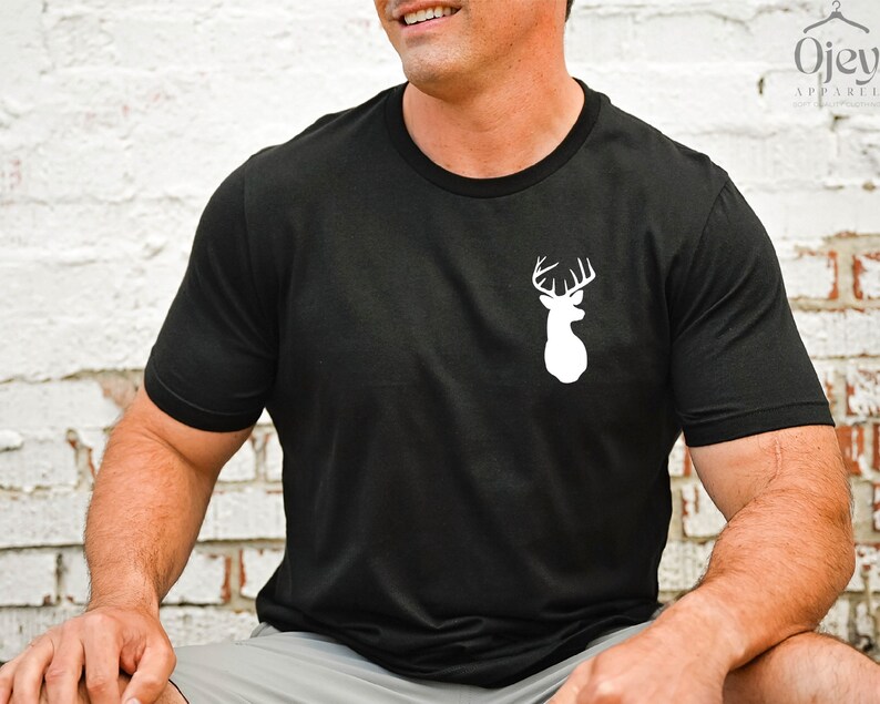 May include: Black t-shirt with a white silhouette of a deer head with antlers.
