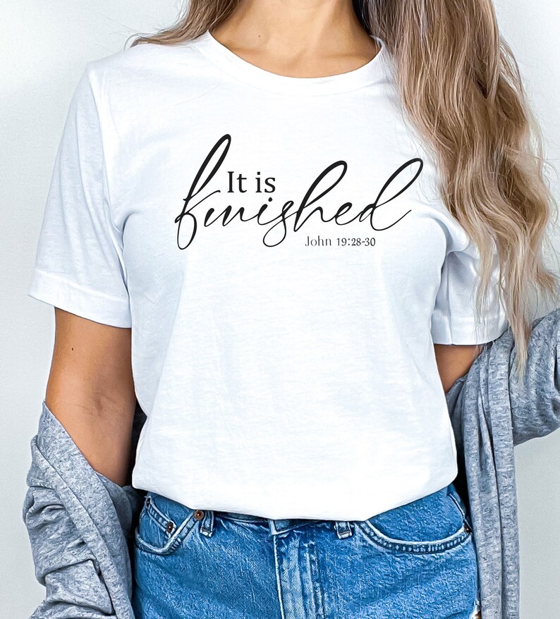 May include: White t-shirt with the text "It is finished" in black cursive lettering and the scripture reference "John 19:28-30" underneath.