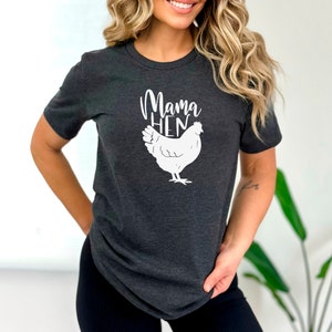 May include: A dark gray t-shirt with a white graphic of a chicken and the text "Mama Hen".