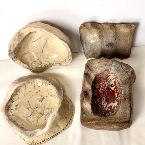 May include: A set of three ceramic mugs with a speckled, matte finish. The mugs are in shades of cream, light gray, and dark gray. Each mug has a simple, minimalist design, perfect for coffee or tea.