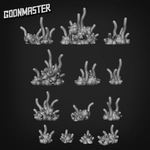 May include: A collection of gray, organic-looking 3D-printed models, possibly for tabletop gaming or miniature scenery. The models feature bulbous shapes with slender, upward-reaching tendrils, resembling coral or alien plant life. The GOONMASTER logo is in the upper left corner.