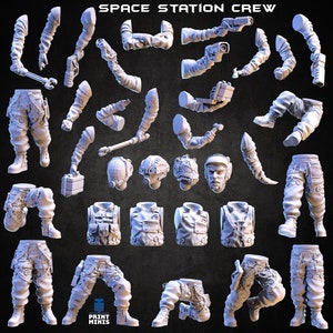 May include: A set of 3D printed miniature figures depicting a space station crew. The figures are in various poses and include different body parts, such as legs, arms, torsos, and heads. The figures are all in a white plastic material.