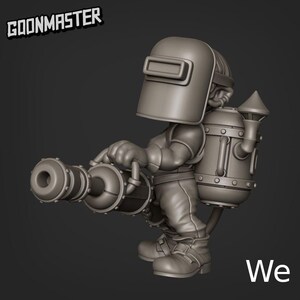 May include: A gray figurine of a character wearing a welding mask and holding a large cannon. The character has a jetpack on their back. The text "GOONMASTER" is above the character, and the word "We" is in the bottom right corner.