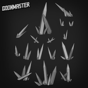 May include: A collection of gray, geometric crystal formations of varying sizes, arranged against a dark background. The text "GOONMASTER" is in the upper left corner. The crystals have sharp, pointed tips.